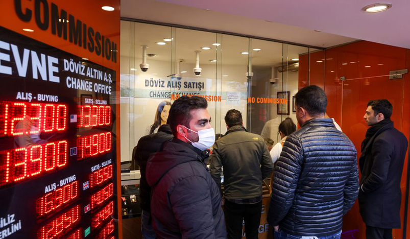 People change money at a currency exchange office in Istanbul